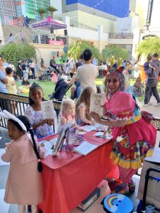 Miss Fairy G at Town Square Las Vegas giving away prizes and entertaining families during a fun community event.