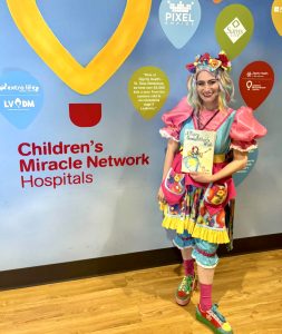 Miss Fairy G entertaining children at a hospital with smiles, laughter, and uplifting family fun.